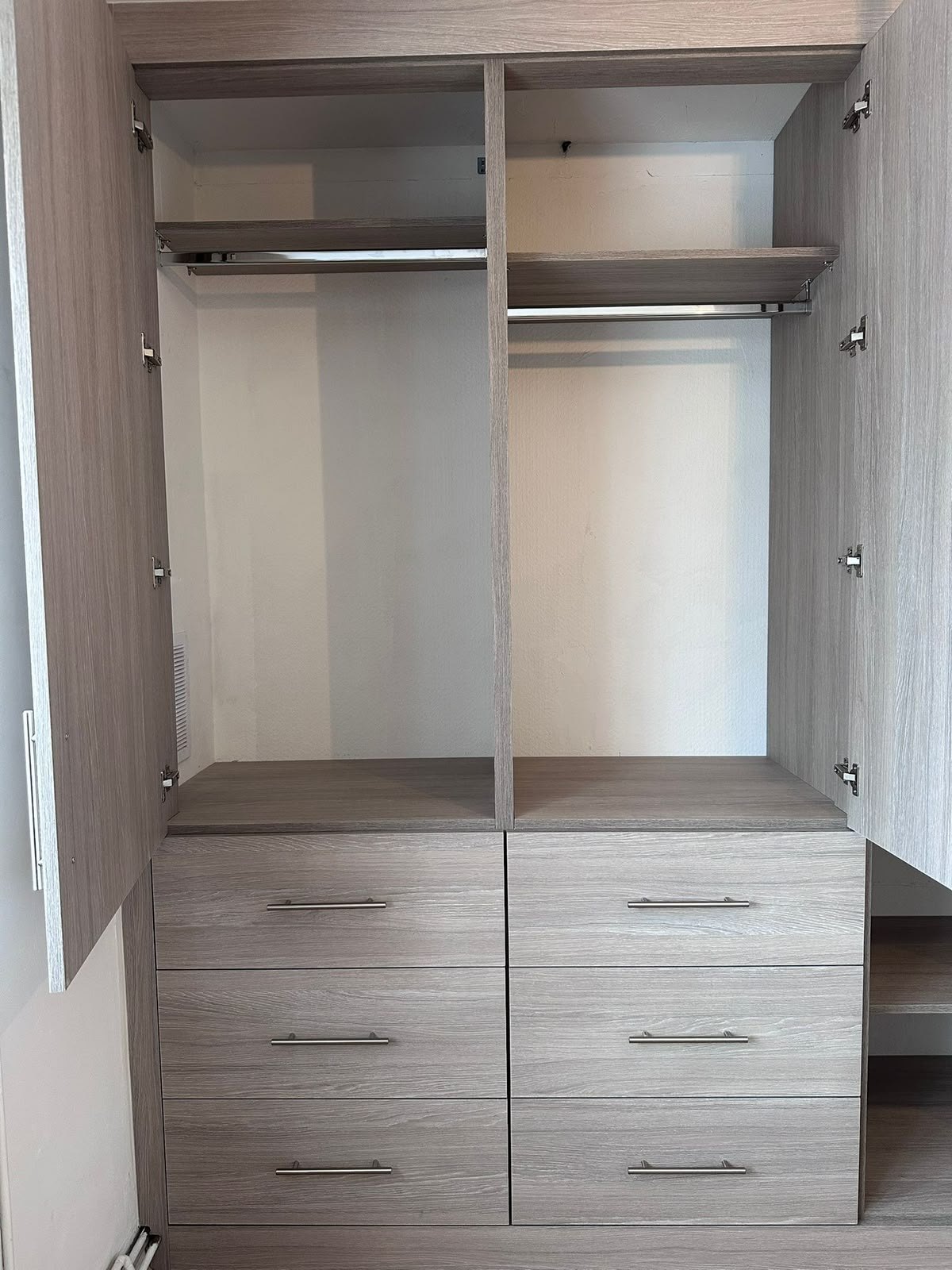 Inside the Feltham wardrobe: two hanging rails, a top shelf and a bank of six drawers